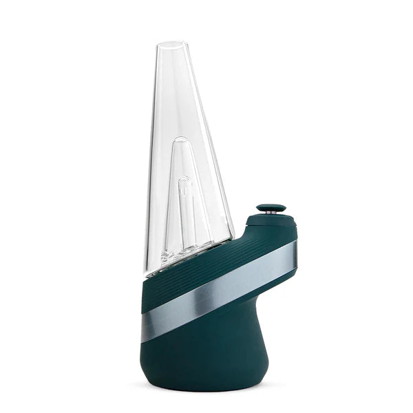 Ein eleganter und moderner Puffco New Peak Vaporizer aus türkisfarbenem Glas mit spitzer Oberseite, silbernem diagonalen Akzent und einem seitlichen Knopf steht aufrecht vor einem weißen Hintergrund.